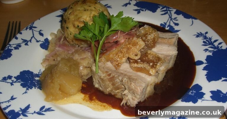Roast pork belly with crisp crackling and apple sauce on a plate