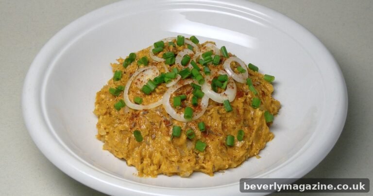 Bavarian obatzda cheese dip topped with onion rings, chives and paprika