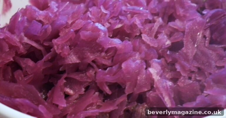 Close-up of braised red cabbage with apples in a white bowl