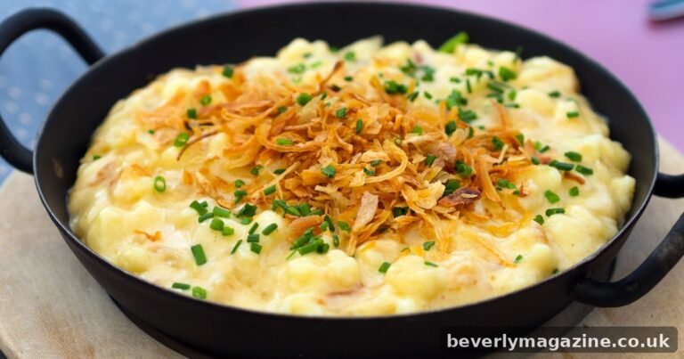 Pan of käsespätzle with melted cheese, crispy fried onions and chives